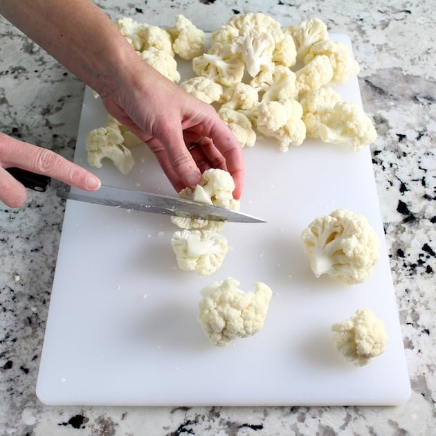 Cutting head of cauliflower into florets on a cutting board