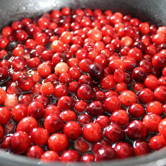 Cranberries and cherries cooking in saucepan for Thanksgiving meal