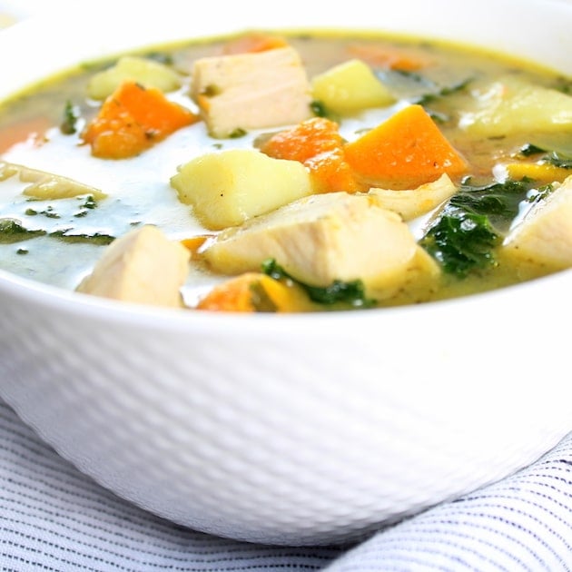 Eye level very close up bowl of Kale and Butternut Squash Turkey Soup