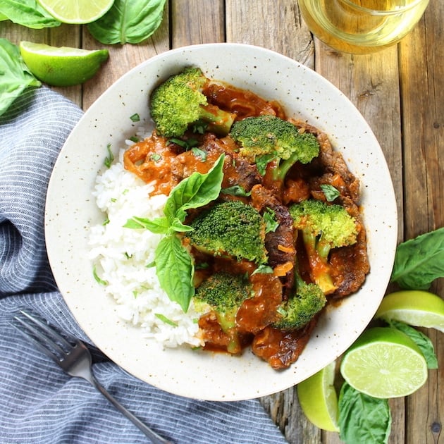 Thai Beef with Broccoli in a bowl with white rice and basil garnish