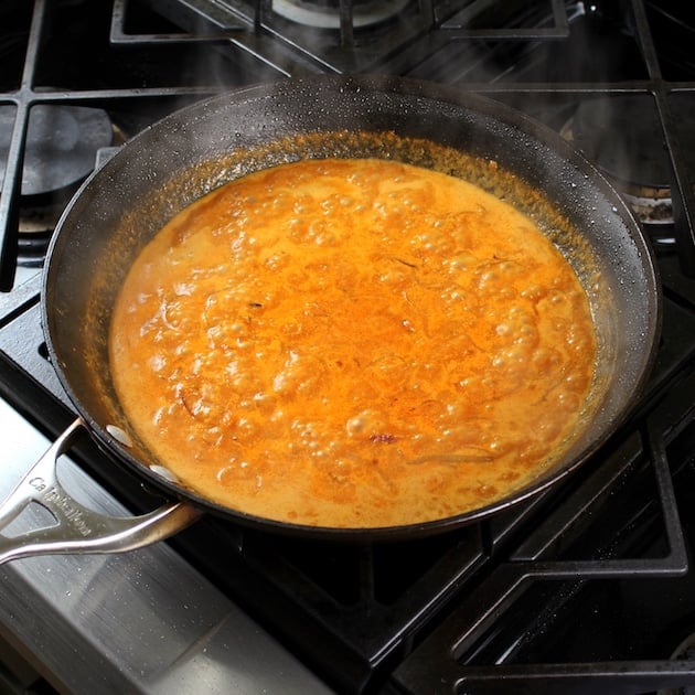 Coconut milk cooking on stovetop