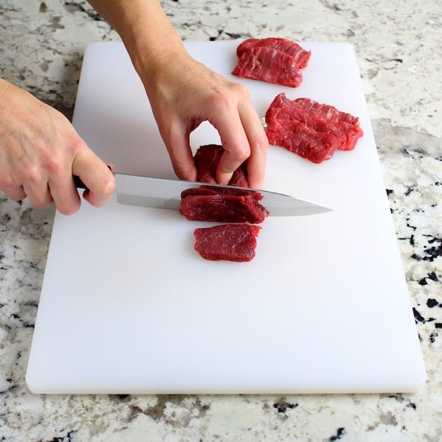 slicing beef on cutting board