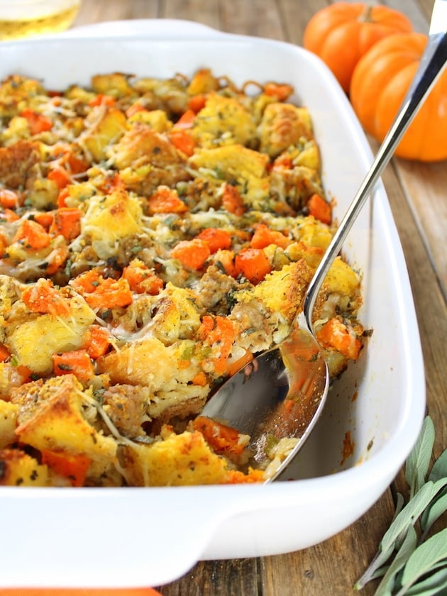 Eye level partial dish is filled with food, with Stuffing and Squash