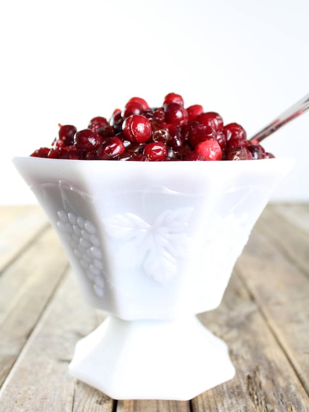 Eye level view of Cranberry And Dried Cherry Sauce in white pedestal serving dish