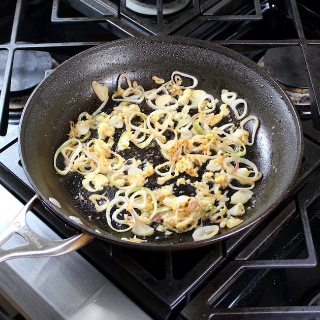 shallots and ginger cooking in saute pan