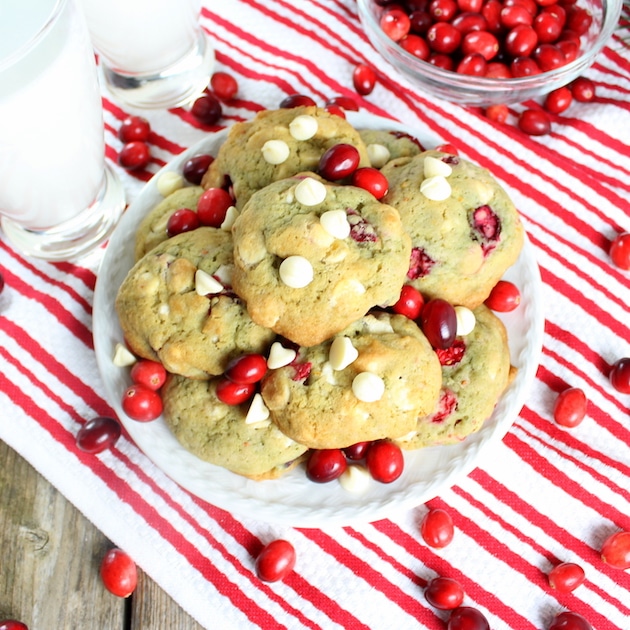 Cranberry Orange Cookies with White Chocolate Chips on a table with a glasses of milk.