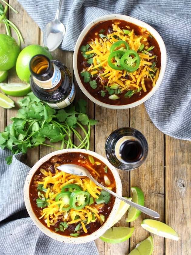 Two bowls of chili with beers