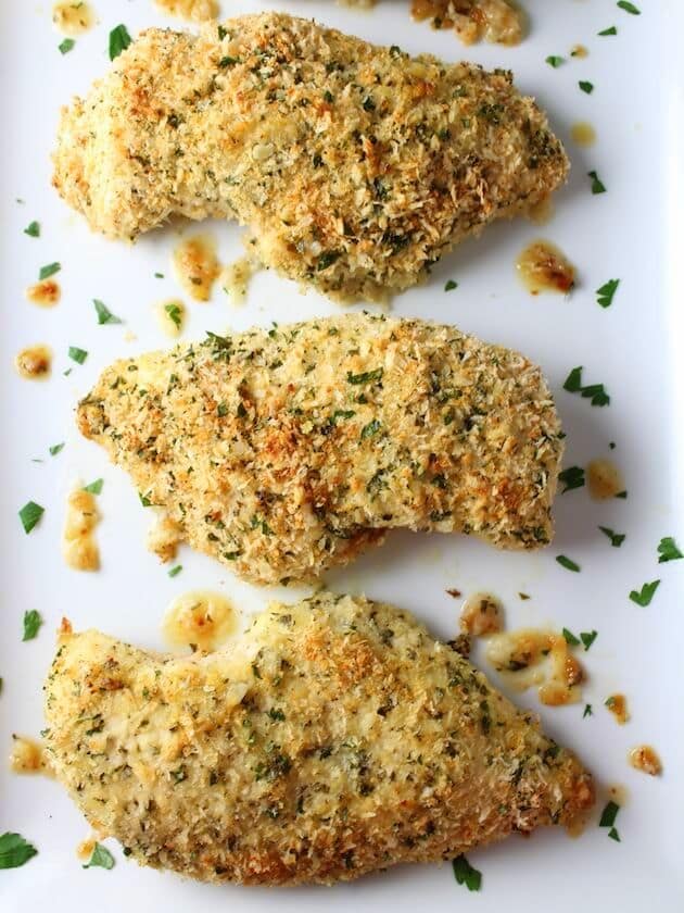Three Parmesan Crusted Chicken breasts on a platter
