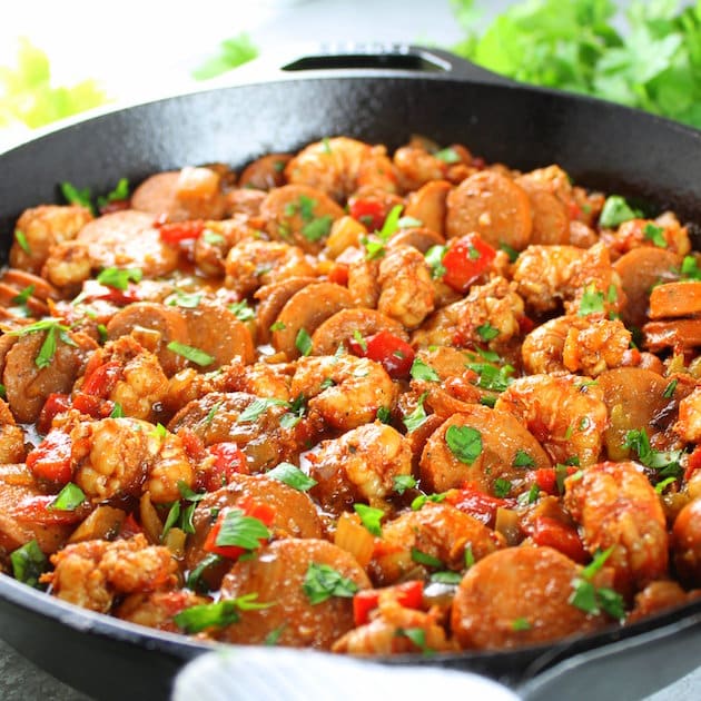 Eye level close up skillet of Andouille Sausage and Cajun Shrimp