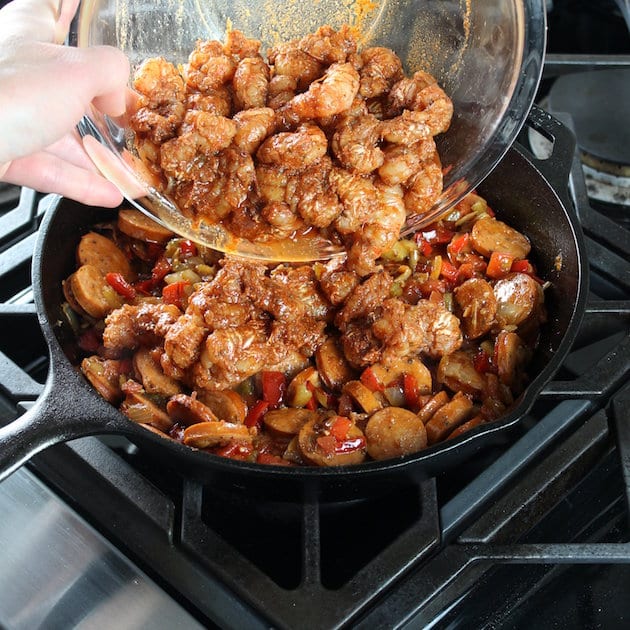 Adding cajun shrimp to skillet