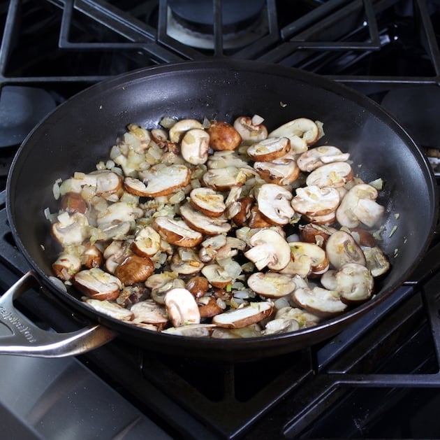 mushrooms and onions cooking in saute pan
