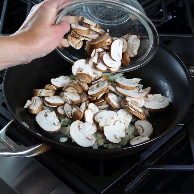 adding cremini mushrooms to saute pan