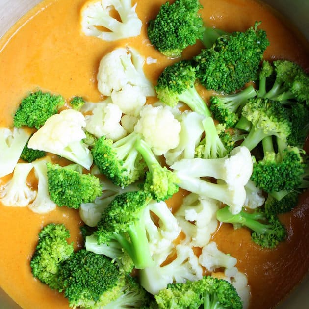 Broccoli and Cauliflower added to soup pot with cheesy base
