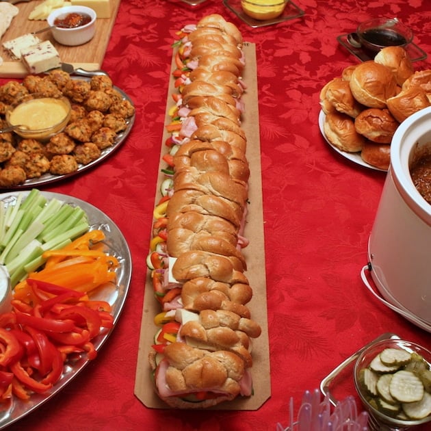 A super long sub sandwich on a holiday tablescape