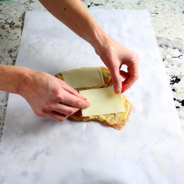 Adding cheese to chicken breasts before cooking