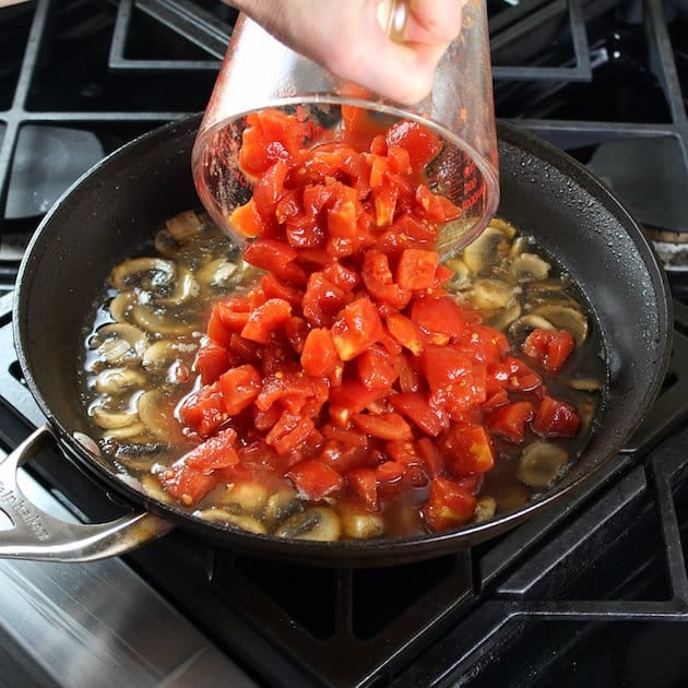 Adding tomatoes to saute pan with italian sauce