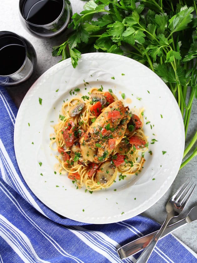 Plated italian Chicken on pasta with red wine