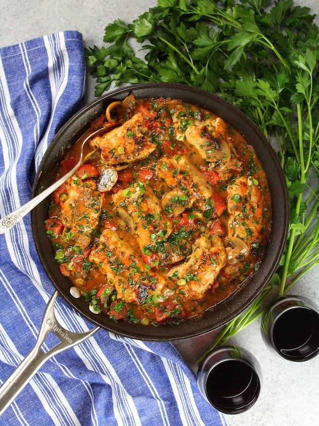 Cooked Chicken Canneloni in skillet with red wine and parsley