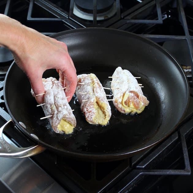 Adding dredged chicken to saute pan