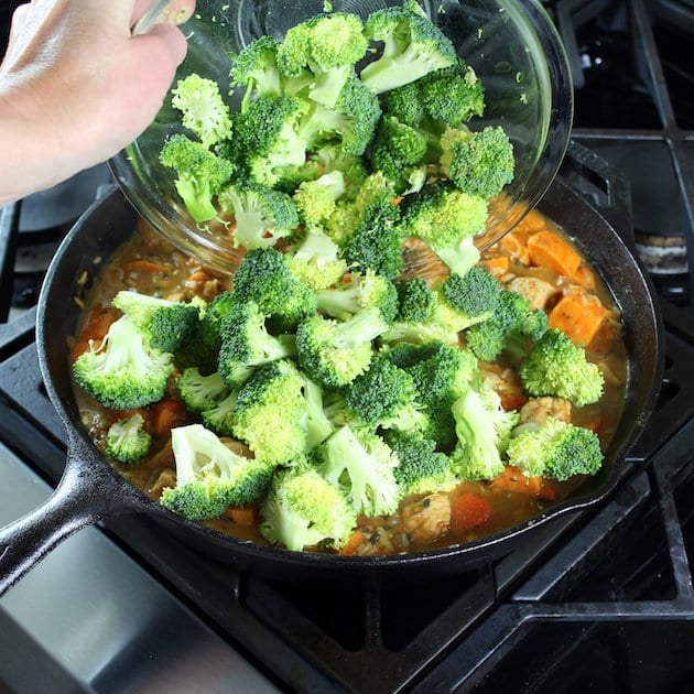 Adding broccoli to a Chicken Skillet with Sweet Potatoes and Wild Rice