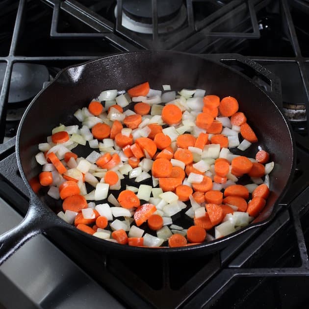 onions and carrots cooking in skillet