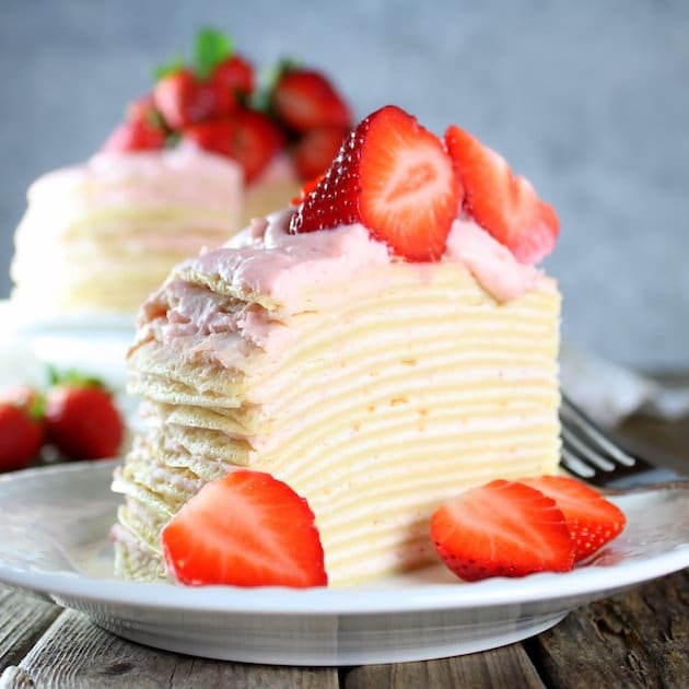 A close up of a slice of cake on a plate, with Strawberry and Mascarpone