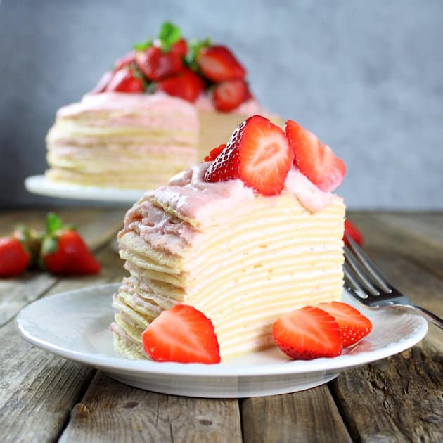 A slice of lemon crepe cake on a plate