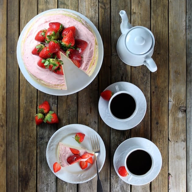 Strawberry Lemon Creme Crepe Cake with two mugs of coffee