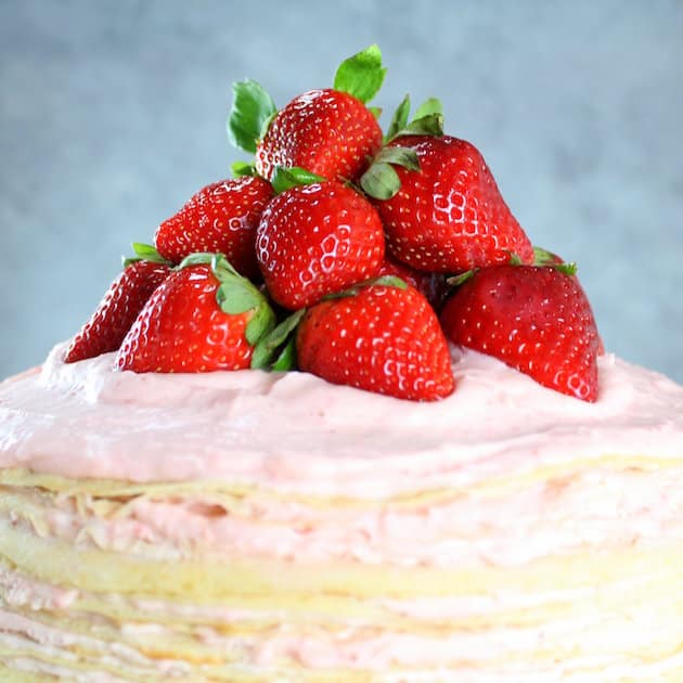 Closeup of Strawberry Lemon Creme Crepe Cake with fresh strawberries on top