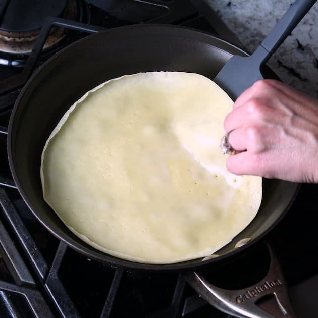 spatula flipping a crepe while cooking