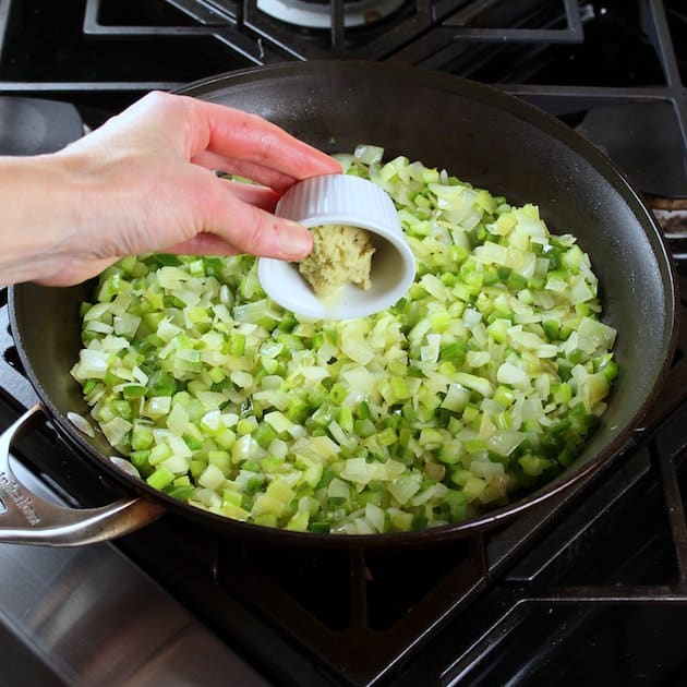 adding ginger to celery and onions in saute pan