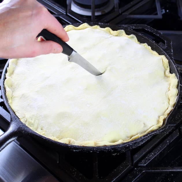 Cutting vents into top of pie pastry before baking