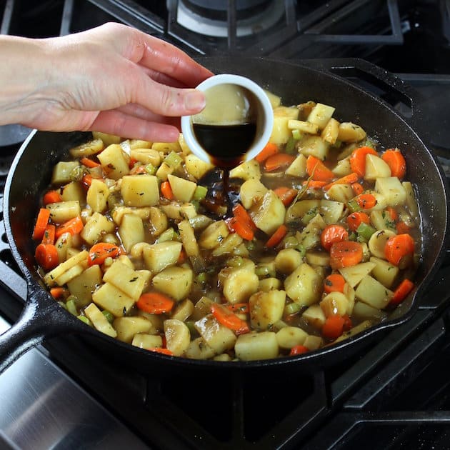 Adding Worcestershire sauce to skillet.