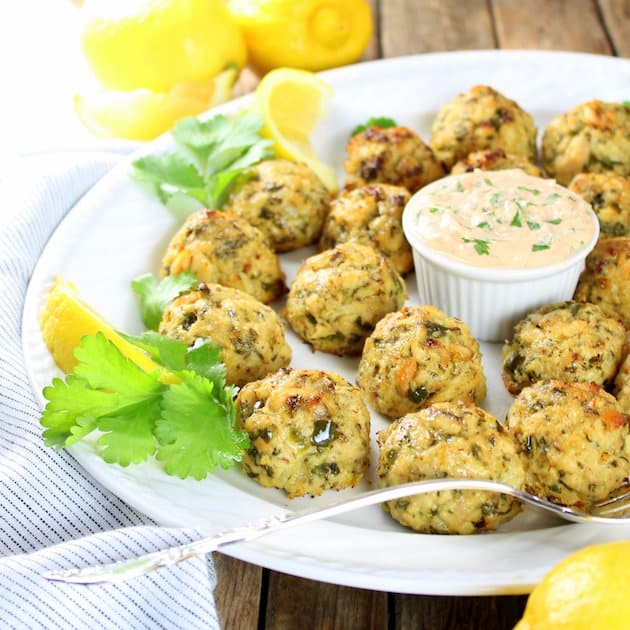 Tuna cakes on platter with yogurt sauce