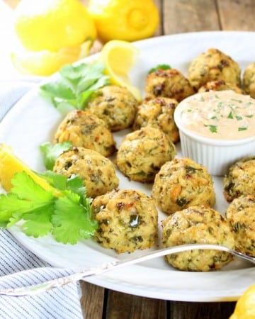 tuna cakes on a platter with yogurt dipping sauce