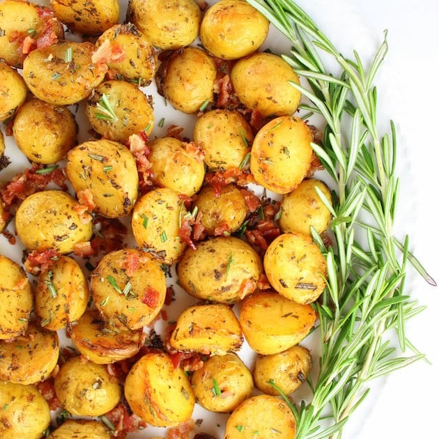 Smoky Salt and Vinegar Roasted Potatoes on a platter with rosemary