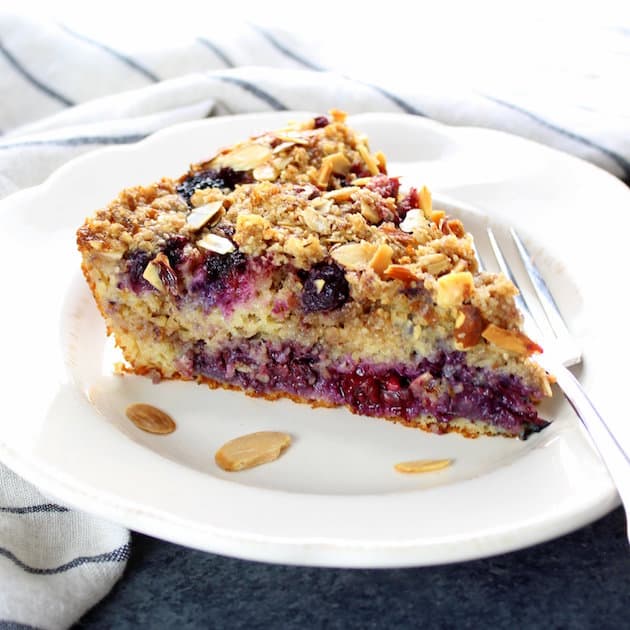 A piece of cake on a plate, with Berry and Oat