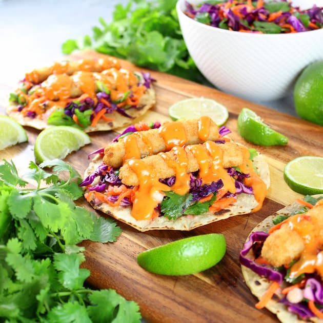 Bang Bang Fish Tacos Recipe Image - With lightly toasted corn tortillas, citrusy cabbage slaw, and fish sticks