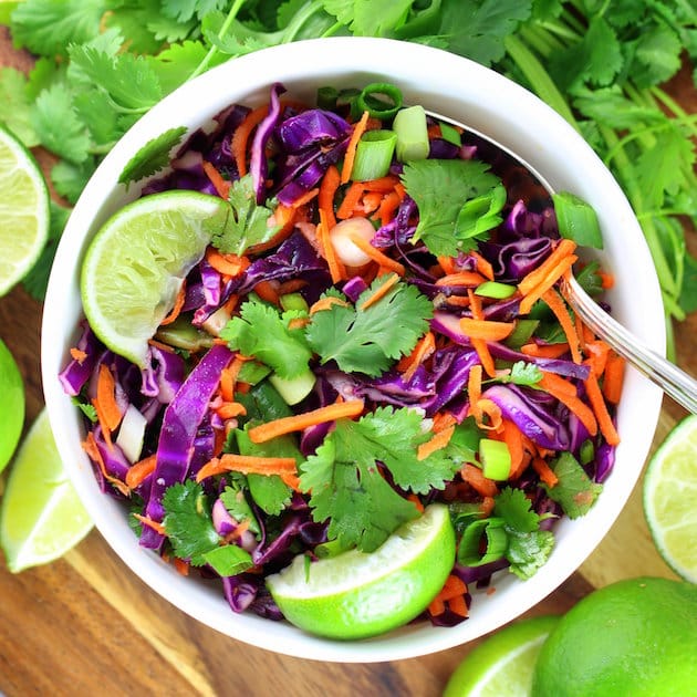 Bowl of bright colored citrus cabbage slaw