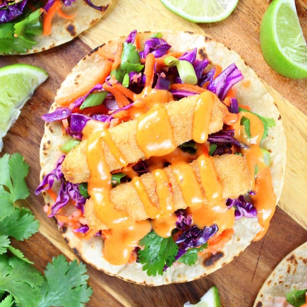 Fish Taco on a cutting board with citrus  cabbage slaw and Bang Bang sauce