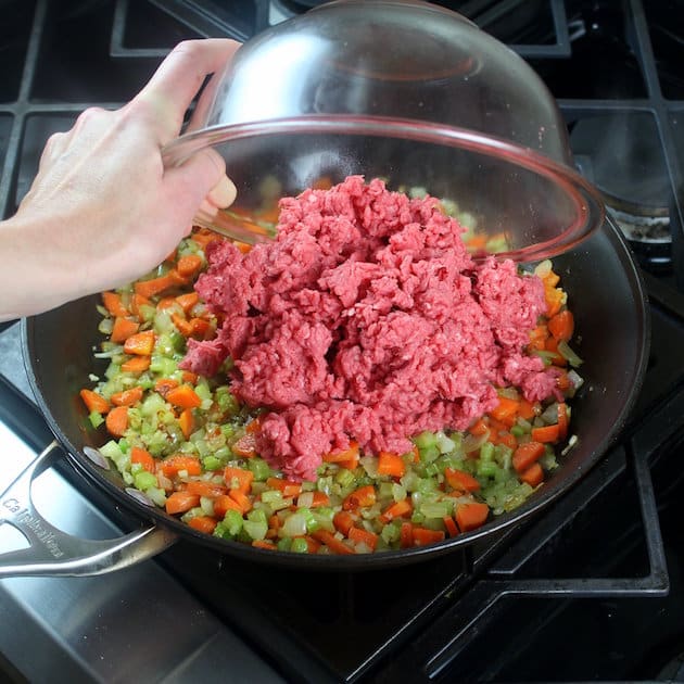 Adding ground beef to saute pan with vegetables