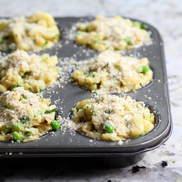 Eye level muffin tin with tuna casserole before baking