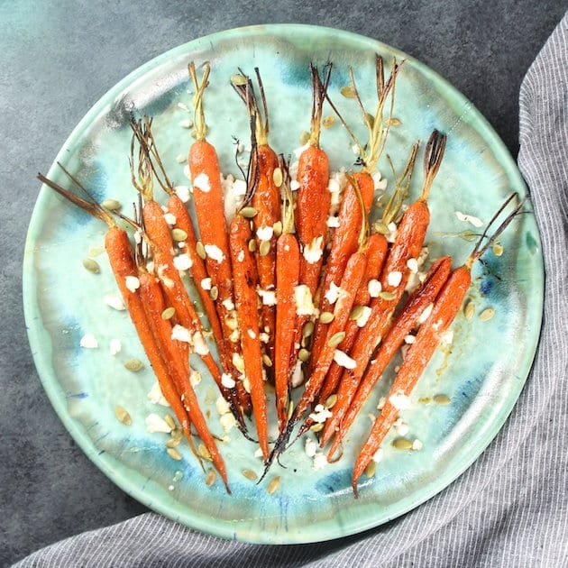 Whole carrots on pottery serving dish