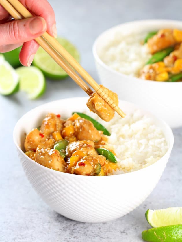 A bowl of rice and vegetables, with Chicken and Snap peas