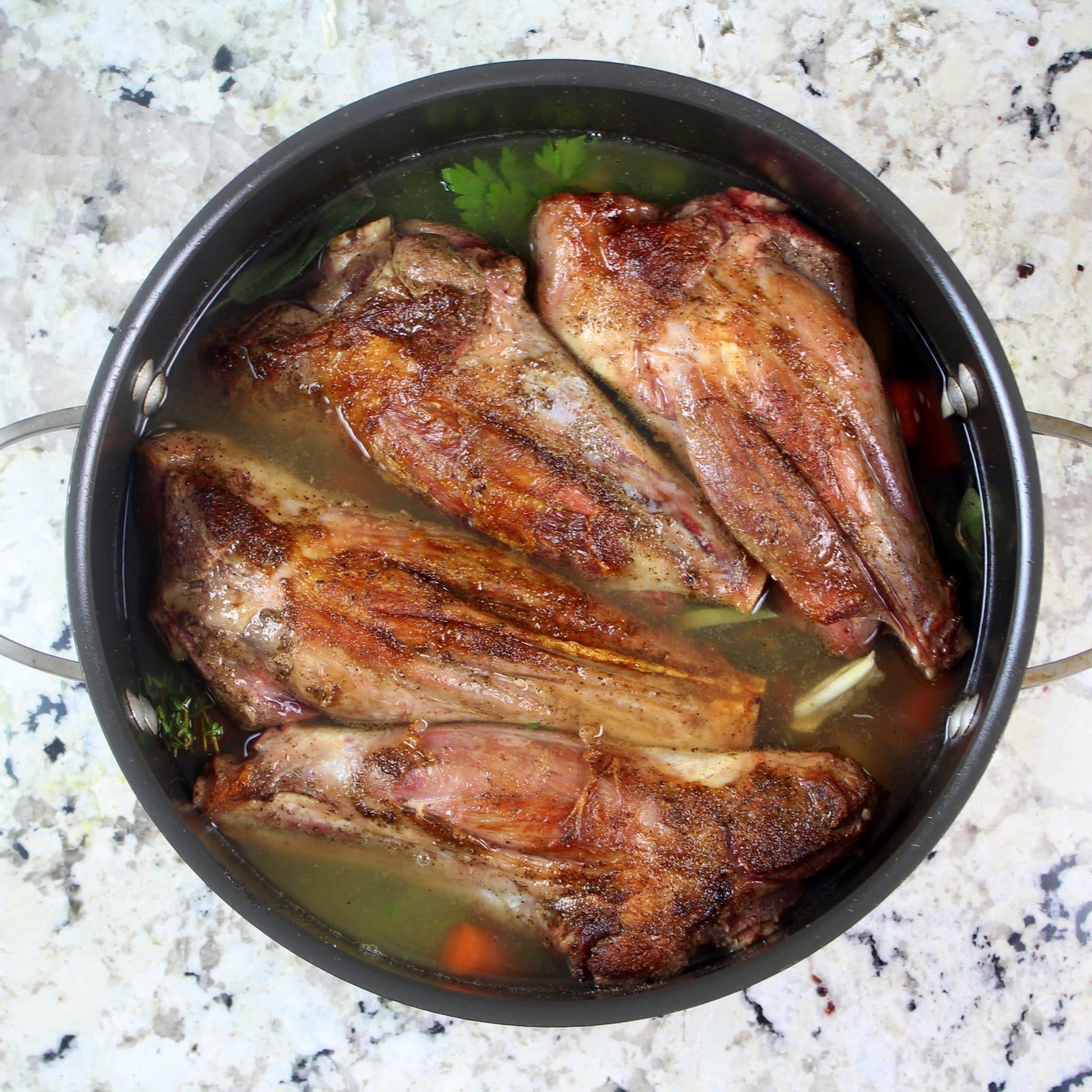 Lamb shanks in a Dutch oven after cooking