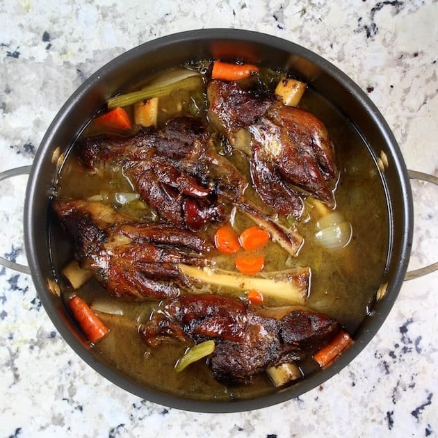 Glazed lamb shanks in a Dutch oven after cooking