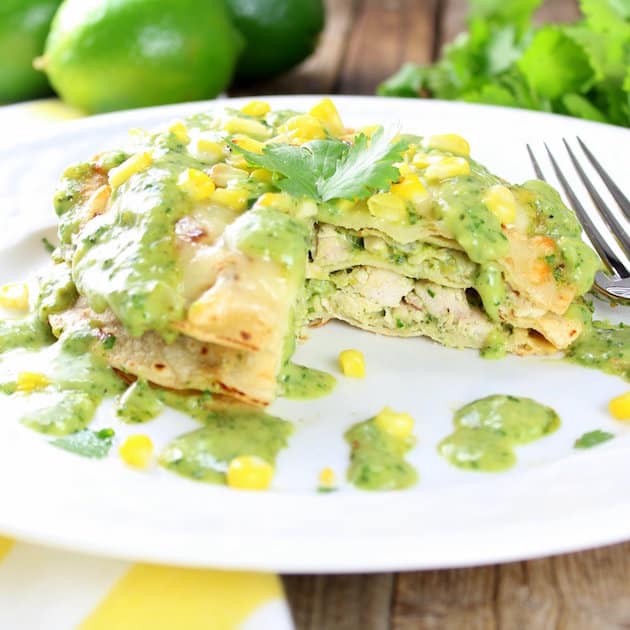 Eye level Stacked Chicken Enchiladas with Cheesy Poblano Sauce 