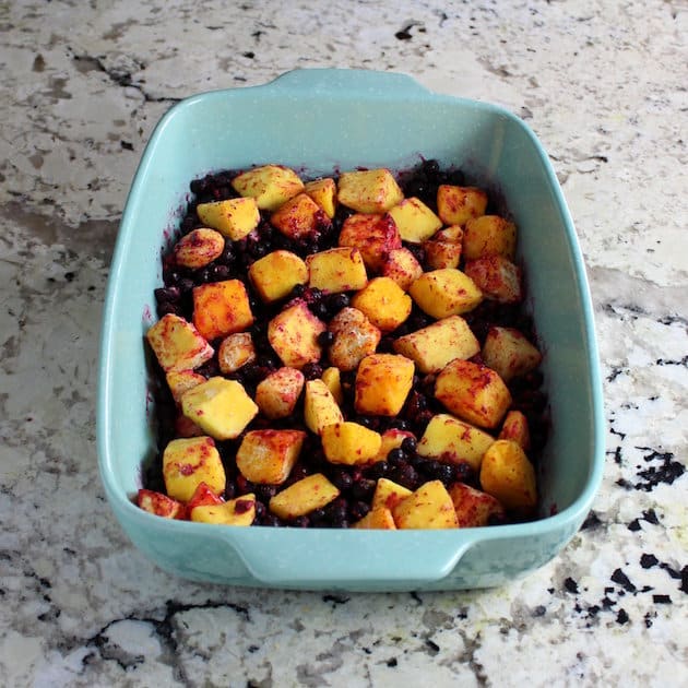 Mangoes and blueberries in a baking dish 