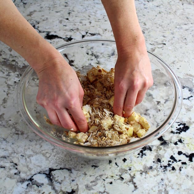 glass mixing bowl with crumble topping for a baked dessert