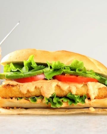 Fish sandwich sitting on top of a table